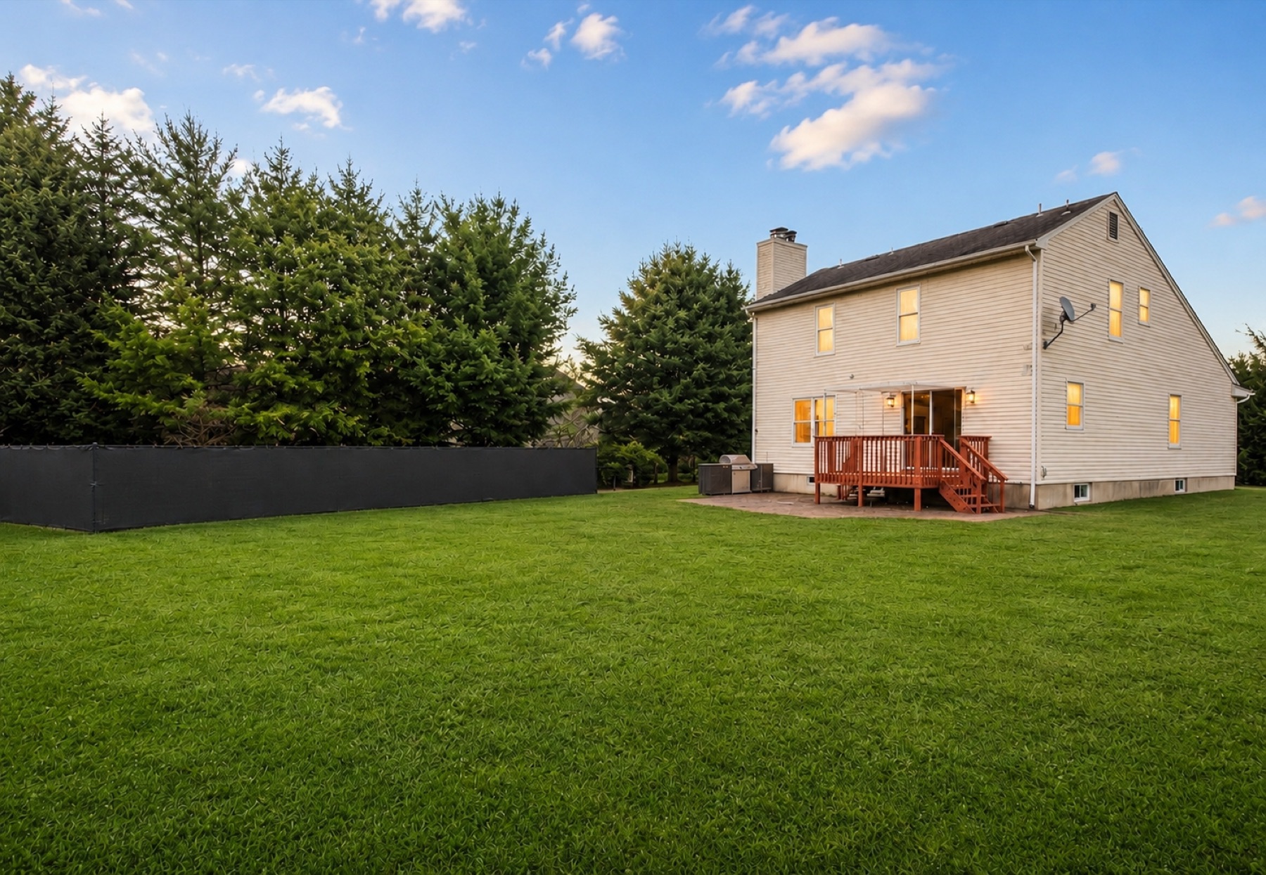 The huge fenced backyard at dusk
